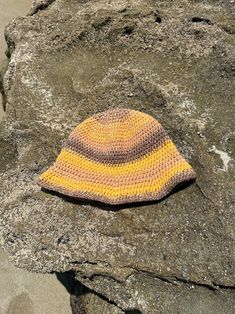 a knitted hat sitting on top of a rock