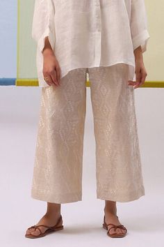 Off white shirt with placed thread embroidered floral motifs. Comes with geometric embroidered pattern pant. - Aza Fashions Elegant Summer Sets With Printed Motifs, Elegant Summer Palazzo Set With Printed Motifs, Elegant Embroidered Summer Pant Set, Elegant Floral Embroidered Pant Set For Summer, Elegant Floral Embroidery Pant Set For Summer, Elegant Summer Pant Set With Floral Embroidery, Elegant Embroidered Cotton Palazzo Set, Elegant Cotton Palazzo Set For Spring, Elegant Spring Cotton Palazzo Set