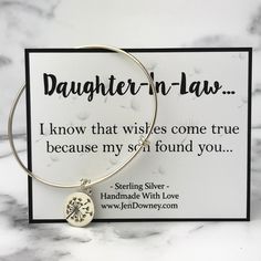 a bracelet with a dandelion charm that says, daughter - in - law i know that wishes come true because my son found you