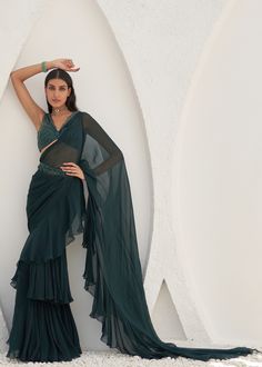 Embroidered blouse with ruffled pre-stitched saree and belt. Designer Ruffled Blouse For Saree, Bollywood Evening Blouse With Ruffles, Formal Pre-draped Saree With Ruffles, Festive Formal Pre-draped Saree With Ruffles, Party Wear Pre-draped Saree With Ruffles For Designer Wear, Formal Festive Ruffled Pre-draped Saree, Designer Georgette Blouse With Ruffles, Formal Georgette Saree With Ruffles, Traditional Pre-draped Ruffled Saree For Evening