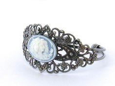 "Two Sisters Cameo Bracelet/Victorian Cameo Bracelet/Cameo/Victorian Cameo Jewelry/Sisters Cameo/Silver Cameo Cuff Bracelet/Wedding Jewelry Victorian Cameo Cuff Bracelet featuring two sisters 25 x 18 mm cameo on a black background set in an antiqued pewter filigree cuff bracelet. Also available in blue. Beautifully detailed antiqued pewter finished brass cuff adjusts to comfortably fit a wrist between 5.75 and 7.75 inches. This is a popular gift for sisters and best friends. Brides - Please conv Daughter Bracelet, Cameo Bracelet, Victorian Cameo, Mother Daughter Bracelets, Jewelry Victorian, 2 Friends, Brass Cuff, Bracelet Wedding, Cameo Jewelry