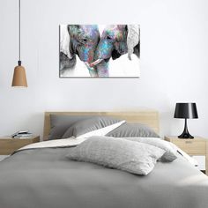 two elephants standing next to each other on a bed in a room with white walls