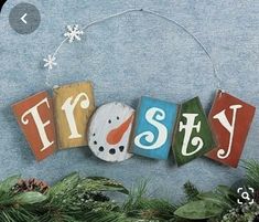 the word frosty spelled out in wooden blocks