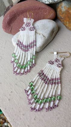 Long Beaded Fringe Earrings.  Comanche Brick Stitched Glass Beaded Earrings in the colors of White Frost, Peridot Green & Purple Amethyst.   Earrings are made entirely of glass beads:  Seed Beads, Bugle Beads and 4mm Peridot Green round glass beads.  Gold Plated Surgical steel ear wires for pierced ears. Length: 3 1/4" (from top of ear wire to bottom of earring).   Width: 1" at widest when worn on the ear. Handcrafted by artist Hanan Hall.   Ships First Class USPS (includes domestic tracking #) from a smoke-free environment. Thank you for visiting www.etsy.com/shop/thefoxandfilly  -  Please favorite my shop as I am continually adding unique & lovely pieces you may not want to miss!  And additional jewelry items in your order qualify for shipping discounts! Please review Shop Policies BEFOR White Beaded Fringe Jewelry For Crafting, Artisan Beaded Purple Earrings, Artisan Purple Beaded Earrings, Traditional Purple Beaded Earrings, Traditional Purple Beaded Earrings For Festivals, Beaded Earrings Native, Native American Earrings, Peridot Green, Bugle Beads