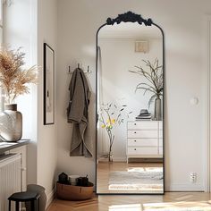 a large mirror sitting on top of a wooden floor