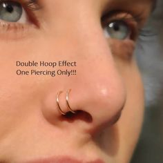 a woman with a nose piercing that says double hoop effect one piercing only on her nose