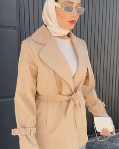 a woman wearing a hijab and sunglasses