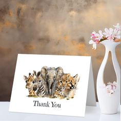 a thank card with three wild animals in front of a white vase and pink flowers