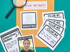 some stickers and a magnifying glass sitting on top of a table with papers