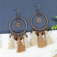 Cream/Tan/Bronze Circular Boho Earrings With Tassel Detail. New Beach Jewelry With Brown Tassels, Bohemian Brown Beaded Tassel Earrings, Summer Brown Tassel Jewelry, Beige Bohemian Jewelry With Fringe, Beige Bohemian Fringe Earrings, Bohemian Beige Fringe Jewelry, Brown Dangle Earrings With Tassels, Brown Dangle Tassel Earrings For Summer, Bohemian Brown Tassel Earrings