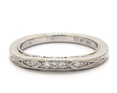 a white gold wedding band with three diamonds