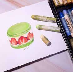 a drawing of a cake with strawberries on it and crayons next to it