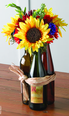 a vase filled with flowers sitting on top of a wooden table