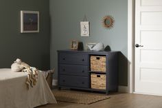 a baby's room with a dresser and bed