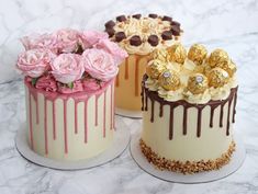 three cakes decorated with flowers and chocolates on top of a marble countertop next to each other