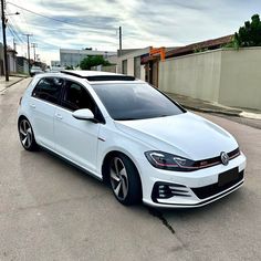 a white car is parked on the street