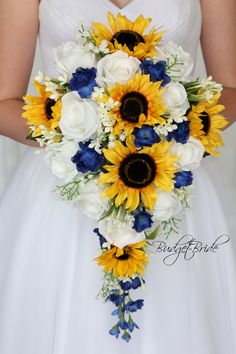 a bride holding a bouquet of sunflowers and white roses in her wedding dress