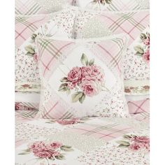 a bed with pink flowers on it and white sheets