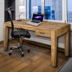 a laptop computer sitting on top of a wooden desk next to a black office chair