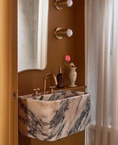 a marble sink and mirror in a bathroom