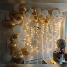 a room filled with balloons and a teddy bear