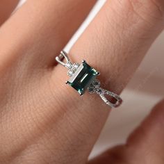 All HANDMADE ITEMS SHIP IN APPROX 8 DAYS Main Stone: Lab created green sapphire Main Stone Size: Emerald cut 5 mm x 7mm Main Stone Weight: 1.16 carat Side Stone: CZs Height From The Ring Setting Bottom(to gemstone top): about 5.05 mm Width of Ring band Measure: gradually varied,about 2.24 to 3.45 mm Material: .925 Sterling Silver/14K White Gold/14K Yellow Gold/14k Rose Gold Engraved: Available For FreeNo more than 13 letters) Customized:Of course! Tell me what you want Includes With Order: All o Emerald Cut Sapphire Jewelry For May Birthstone, Emerald-cut Sapphire Jewelry For May Birthstone, Gift Emerald Ring With Square Diamond Cut, Rectangular Sterling Silver Emerald Ring For Wedding, Elegant Silver Emerald Ring With Rectangular Stone, Elegant Sterling Silver Emerald Ring With Rectangular Stone, Rectangular Emerald Ring In Sterling Silver For Wedding, Rectangular Silver Emerald Ring For Wedding, Elegant Silver Sapphire Ring With Emerald Cut