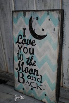 i love you to the moon and back painted on an old wooden sign with stars