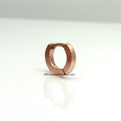 Handmade from solid 14K rose gold. This tiny hoop earring measures approximately 5mm inner diameter. Great for helix, tragus, anti tragus, daith, eyebrow, or rook piercings. Sold as a single hoop cartilage earring. Product attributes Metal: high quality 14K solid rose gold Inner diameter: 5mm Width: 1.4mm Ear post: 20G. Can be customized to other gauges. 14K white gold polished https://www.etsy.com/listing/127764306 14K white gold matte https://www.etsy.com/listing/179694245 Thank you for your i Tragus Daith, Anti Tragus, Earring Cartilage, Raspberry Smoothie, Tiny Hoop Earrings, Cartilage Earrings Hoop, Cartilage Earring, Gold Polish, Cartilage Earrings