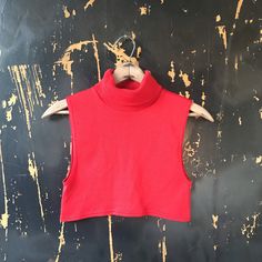 "Such a cute vintage 70's red turtleneck sleeveless crop top. Pullover entry. Stretchy and comfortable. Woven acrylic/spandex. Great vintage condition. Made in the USA. Size medium. Fits like an extra small-medium. The cutest top ever for real! Would look great styled so many different ways. Measurements: laying flat. Fabric stretches. Length: 12.5\" Armpit to armpit: 14+\"" Retro Red Sleeveless Tank Top, Fitted Sleeveless Crop Top For Fall, Red Cropped Stretch Tank Top, Red Stretch Cropped Tank Top, Red Sleeveless Stretch Crop Top, Stretch Red Cropped Tank Top, Red Fitted Cropped Tank Top, Red Retro Spring Tank Top, Retro Red Spring Tank Top