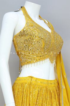 Wear a light yellow lehenga choli from palkhi fashion, Where tradition meets contemporary charm. Lehenga is highlighted with full flair, pure georgette fabric, petite sequin embroidery, and threadwork. The matching halter neck blouse is enriched with mirror work, pearl, kundan, and handwork. It comes with a full-length pure georgette dupatta crafted with thread embroidery, and sequins work, which add extra charm. Lehenga Designs Yellow, Light Yellow Lehenga, Lehenga Blouse Designs Latest, Halter Neck Blouse Design, Yellow Blouse Designs, Yellow Lehenga Choli, Palkhi Fashion, Halter Neck Blouse, Halter Neck Blouses