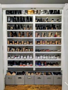 the closet is filled with many pairs of shoes and bins for storing them in