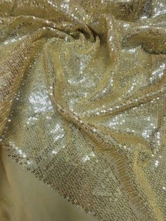 the fabric is shiny and gold with some silver sequins on it's side