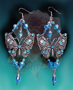 "These Handmade Sparkly Crystal Butterfly Chandelier Earrings are made with crystal beads and plated metal butterflies. Hand-set Swarovski rhinestones add an intense sparkle! ...truly magical! Available with French Wires, Posts or Clip-Ons. -5\" Long x 2\" Wide -0.4 oz. ea. -Many Colors Available in the pull-down menu!  Light Violet is seen in the video. Metal Finishes Available: -Antique Silver -Bronze -Antique Gold *Please note the color options are shown on a white background and are represen Metal Butterflies, Butterfly Chandeliers, Magical Crystal, Light Violet, Crystal Butterfly, Jewelry Antique, Sparkly Earrings, French Wire, Fantasy Jewelry