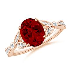 a ring with a large red stone and white diamonds on the band, set in 18k rose gold