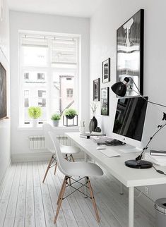 an office with white walls and wooden floors