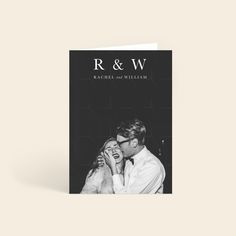 a black and white photo of a couple kissing on the cover of their wedding album