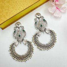 Oxidized Emerald Stone Peacock Dangler Earrings Indian Handmade Beautiful White Pearl Stone Earrings for Women Ethnic Unique Design Jewelry These stylish Peacock Dangler Earrings from VASTRABHUSHAN will certainly leave you spellbound. These Danglers have an excellent finish and gives out an exquisite sense of style. If you are looking for an amazing Fashion Jewelry for special occasions such as Anniversary, Engagement, Party, Wedding or for gifting , then your search ends here. The look is stunn Bohemian Bridal Earrings With Intricate Design, Bohemian Drop Earrings For Festive Bridal Wear, Festive Bohemian Drop Bridal Earrings, Bohemian Bridal Earrings With Intricate Design For Diwali, Bohemian Peacock Design Danglers For Festivals, Festive Green Bohemian Earrings, Bohemian Peacock Danglers For Festivals, Peacock Design Dangle Chandelier Earrings, Silver Peacock Design Earrings For Party