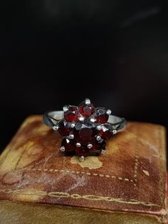 Here we have a beautiful vintage ring featuring a sparkling cluster of natural garnet gemstones set in sterling silver UK size - N US size - 6.75  Message me any questions  ITEM - S1858 Vintage Multi-stone Cluster Ring, Vintage Multi-stone Cluster Ring For Anniversary, Vintage Garnet Birthstone Rings, Collectible Cluster Gemstone Rings, Vintage Multi-stone Cluster Ring For Formal Occasions, Vintage Cluster Ring Suitable For Gifts, Heirloom Cluster Ring Gift, Vintage Gemstone Cluster Ring, Vintage Red Gemstone Cluster Ring