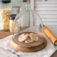 some cookies under a glass dome on a table