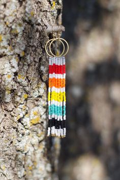 Brighten any get up with these beautiful striped beaded fringe earrings in vibrant hues reminiscent of sunset. They're vailable in (main color) black or white, and make a wonderful daily pop of color or gift for a loved one.  These earrings are designed for all day wear,  weighing about 2.8 g (small) / 4.4 g (large) and 4 in (small) / 5 3/8 in (large) in total length. ----- Love your product? I'd love to see it! Share a photo and consider leaving a review. You can also tag me on instagram at @mz_handcrafts!  Have a question? Please reach out! ----- Notice: Photos provided are product mockups to provide an example of the product you'll receive. I personally take my photos, so you can be sure they are an accurate representation of my work. Additionally, colors shown may vary slightly due to Bohemian Rainbow Beaded Earrings With Fringe, Rainbow Fringe Dangle Jewelry, Multicolor Fringe Jewelry As A Gift, Rainbow Dangle Tassel Jewelry, Bohemian Rainbow Tassel Earrings As Gift, Multicolor Fringe Dangle Jewelry, Mexican Art Tattoos, Earrings Boho Chic, Beaded Fringe Earrings