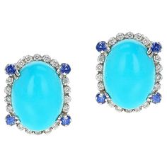 A Turquoise Oval Cabochon Earrings with Diamonds and Sapphire, 18k. The total weight of the diamonds is 0.80 carats and the sapphires weigh 0.40 carats. The earrings weigh 11.88 grams and the size is 0.75" x 0.60". The turquoise is 10 x 12 MM. Cabochon Earrings, Oval Cabochon, Diamond Earrings, Gemstone Rings, Sapphire, Jewelry Earrings, Diamonds, Turquoise, Gemstones