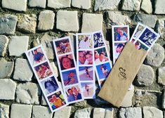 several polaroid photos laid out on the ground next to a paper bag with an envelope