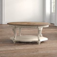 a white coffee table in a room with hardwood floors and walls on either side of it