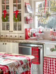 a kitchen decorated for christmas with red and white decor