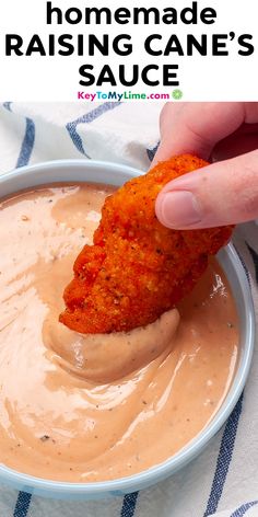 a person dipping some kind of sauce in a bowl with the words homemade raising cane's sauce