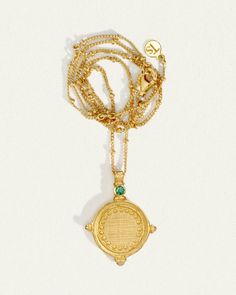 The Sura Necklace in cross-brushed 18K Gold Vermeil is reminiscent of an ancient coin with its embossed detail and circular shape. Set upon a fine chain enhanced by delicate gold bead elements. A faceted emerald, a quintessential symbol of love, at the tip of 4 symmetrical points completes the design. The Sura Necklace allows you to be open to receiving love from others. Timeless Gold Emerald Necklace, Gold Emerald Jewelry With Engraving, Gold Jewelry With Coin Pendant For May Birthstone, Gold Engraved Emerald Jewelry, May Birthstone Jewelry With Round Coin Pendant, May Birthstone Spiritual Jewelry With Coin Pendant, Engraved Emerald Gold Jewelry, Engraved Gold Emerald Jewelry, Green Coin Pendant Medallion Jewelry