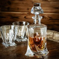 an old fashioned decanter and glasses on a table