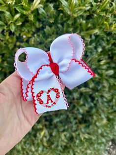 This listing is for 1 embroidered Valentine's Day moonstitch hair bow with embroidered initial and floral heart design. The ribbon color show is white with red and pink moonstitch. The medium bow measures approximately 4 inches wide and is made from 1.5 inch moonstitch grosgrain ribbon. The large bow measures approximately 5.5 inches wide and is made from 2.25 inch moonstitch grosgrain ribbon. Bows will be attached to an alligator clip unless otherwise requested. This bow will complete your girl Cute White Bow With Ribbon, White Bow Hair Accessory For Gift, Cute White Ribbon Bow, White Ribbon Bow For Spring, White Bow Hair Accessories As Gift, White Bow Hair Accessories For Gifts, White Ribbon Bow For Gift, Personalized White Craft Supplies For Gift, Girls Valentines Outfit