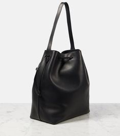 Belvedere leather bucket bag in black - The Row | Mytheresa Leather Hobo Bag With Bucket Shape, Formal Soft Leather Bucket Bag, Classic Calf Leather Bucket Bag For Shopping, Luxury Black Calf Leather Bucket Bag, Modern Calf Leather Bucket Bag For Daily Use, Leather-lined Bucket Bag For Shopping, Leather Bucket Bag For Formal Occasions, Calf Leather Tote Bucket Bag For Travel, Leather Lined Bucket Bag For Shopping