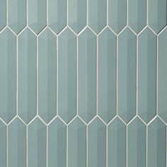 a close up view of a wall made out of hexagonal tiles in light blue